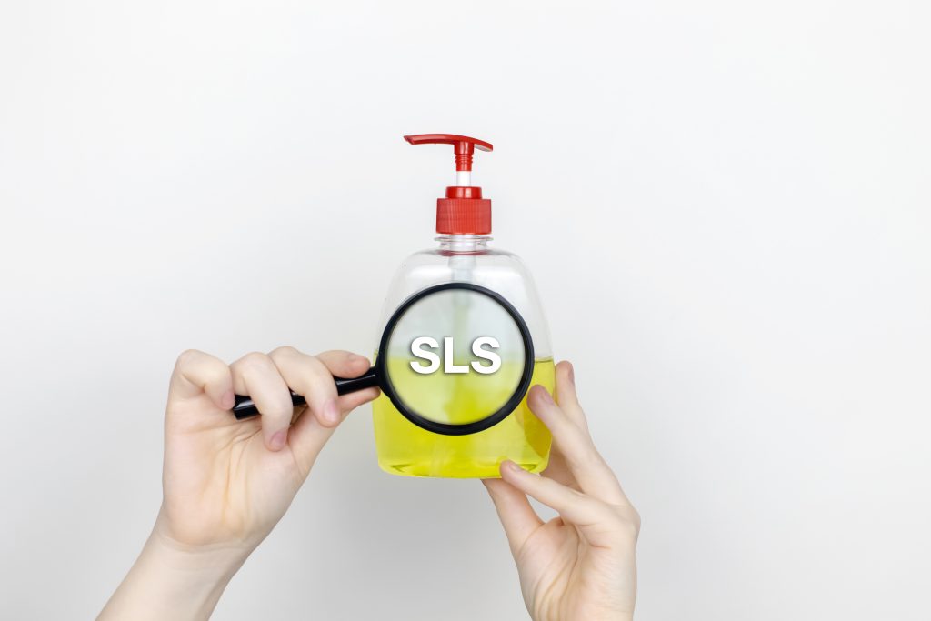 magnifying glass over hand soap revealing SLS