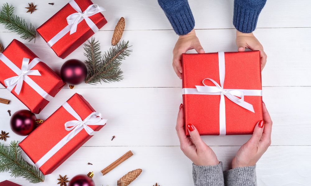 young boy handing mum wrapped present 
