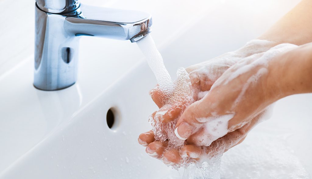 person washing their hands 